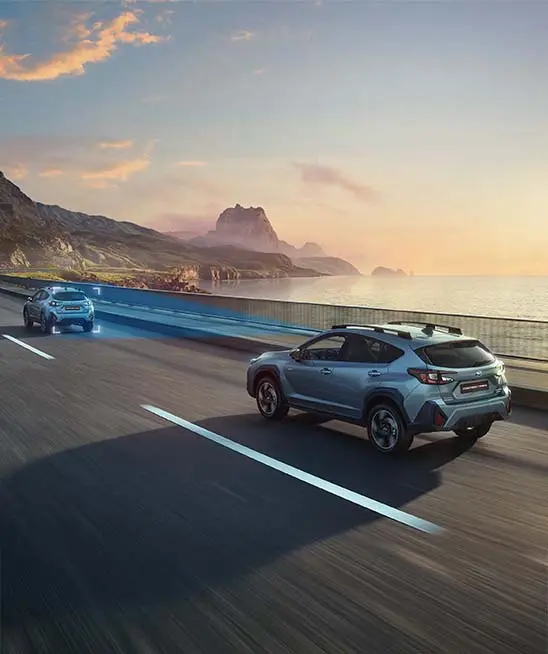 Offshore blue metallic Subaru Crosstrek driving on road