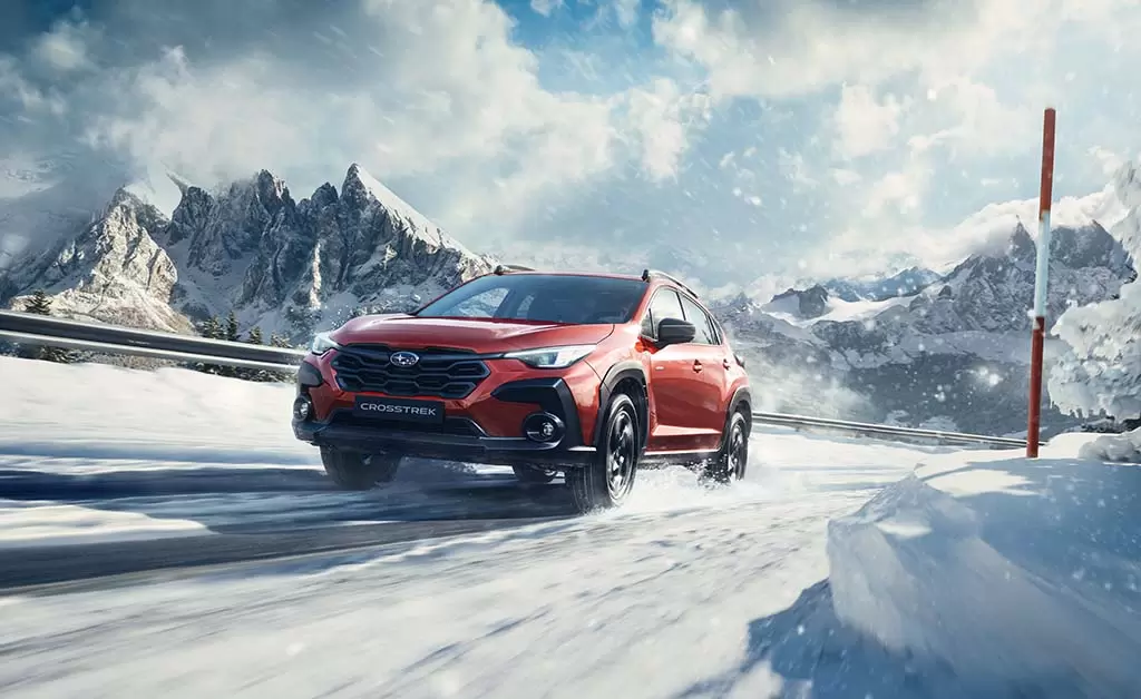 Sunblaze pearl Subaru Crosstrek parked in snow