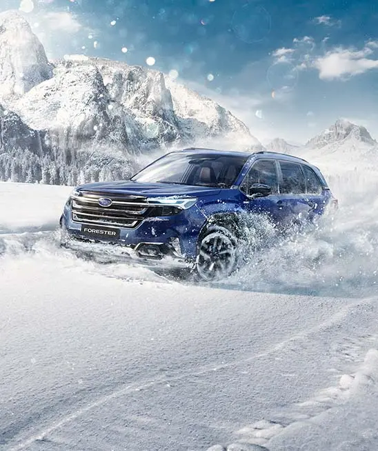 Sapphire Blue Pearl Subaru Forester driving through the snow 